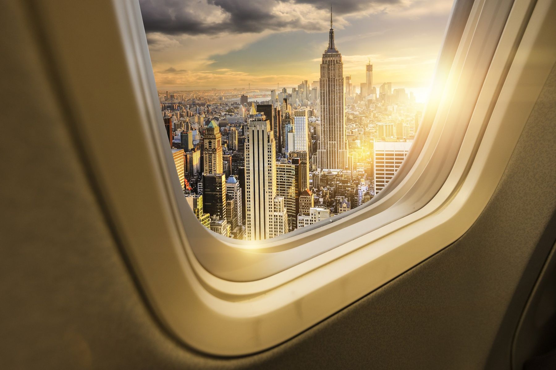 The Manhattan skyline at sunset, seen through an aircraft window